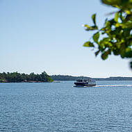 A wonderful sunny day where a vessel is crossing the waterside.