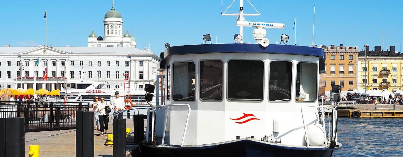 A ship is moored at the quay in Helsinki harbor in beautiful weather. 