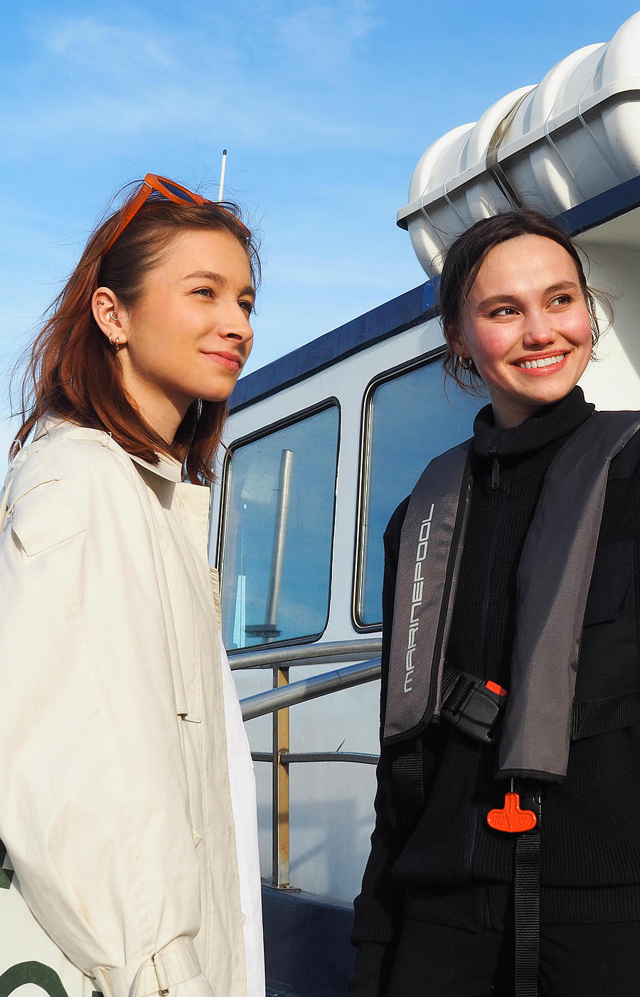 Two women are on a raft, and one of them is being given directions.