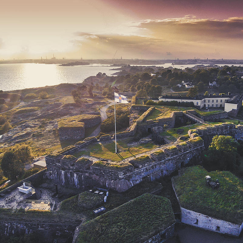 A bird's eye view of Suomenlinna Castle at sunrise.